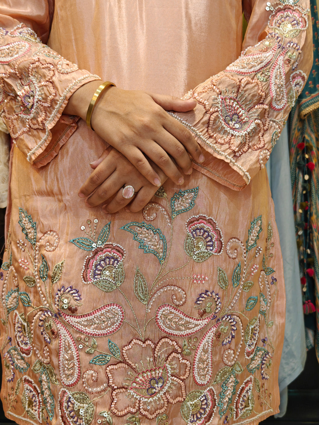Coordinated peach palazzo pants paired with embroidered tissue shimmer kurta
