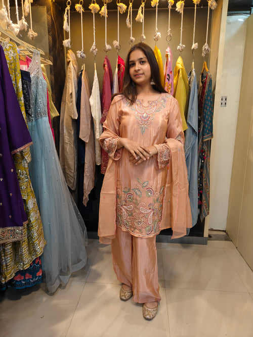 Front view of peach hand-embroidered tissue kurta with pastel threadwork