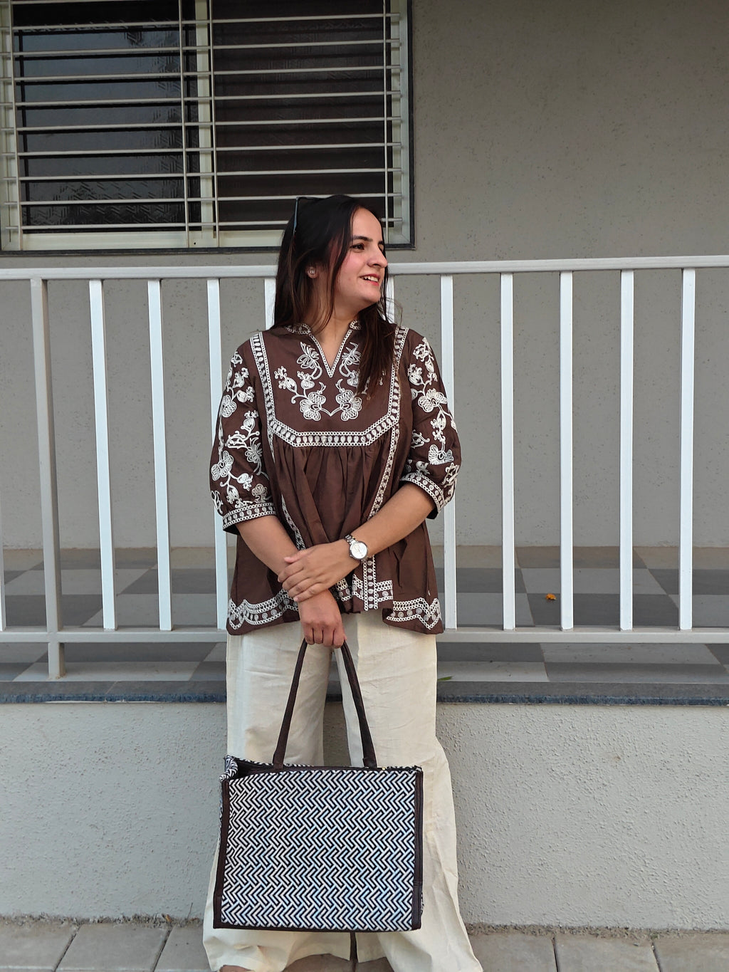 Off-white wide-leg cotton trousers paired with coffee brown embroidered tunic